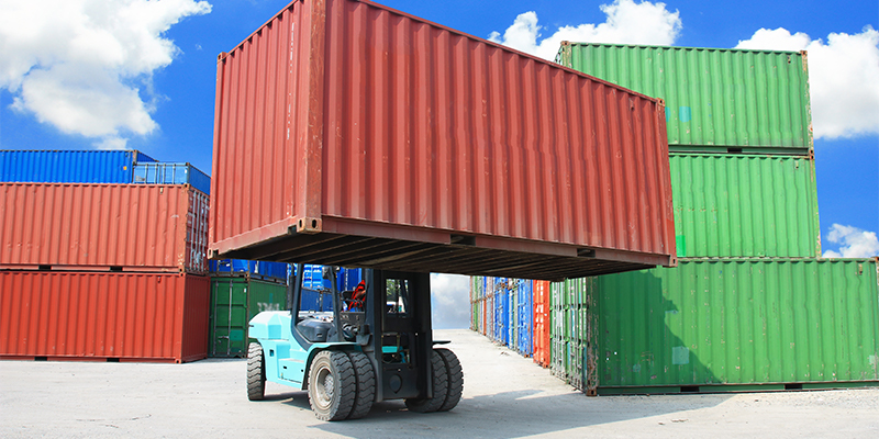 Forklift carrying a container